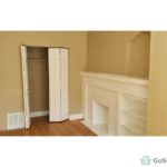 An image of an unfurnished room with empty closet