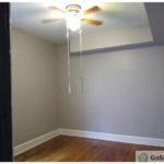 An inside image of an empty unfurnished room with ceiling fan