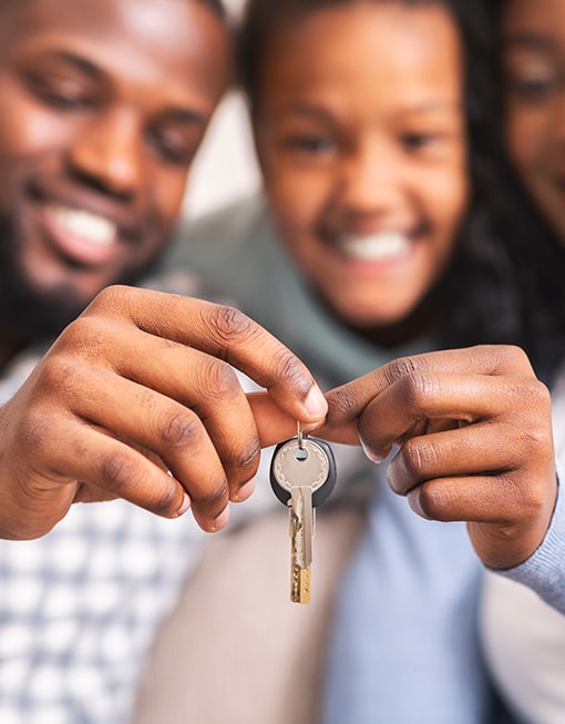 An image of a family holding a key together