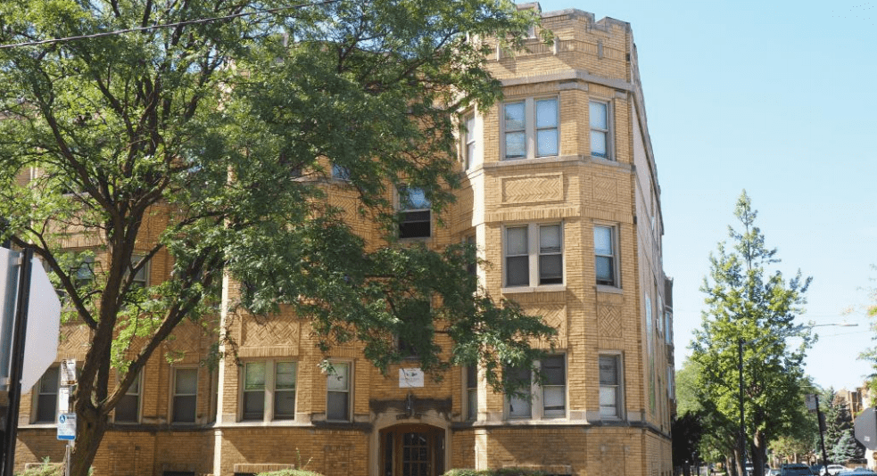 A yellow brick multi-family home managed by Medallion Property Management
